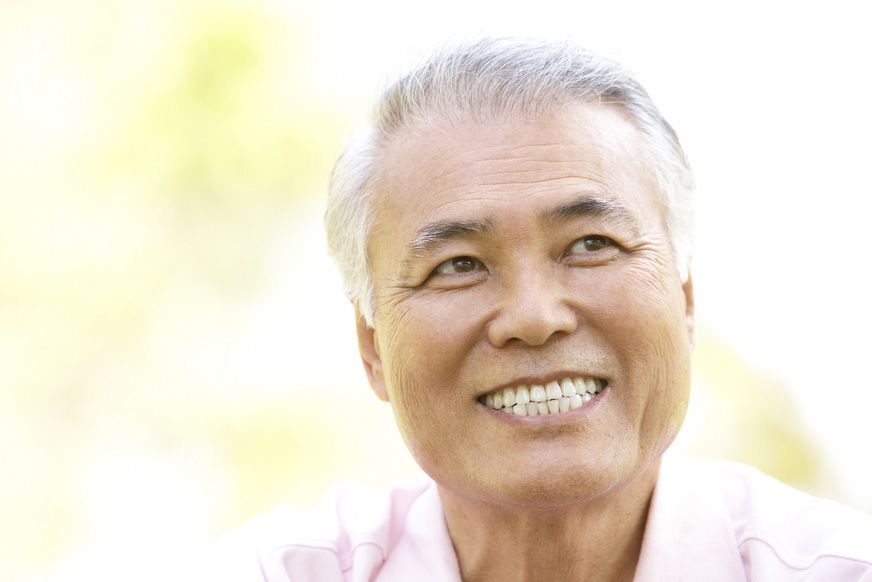 An older man shares a healthy smile