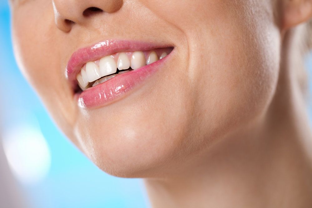 A woman shares a healthy smile